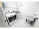 Functional laundry room with modern appliances, a utility sink, and tiled flooring at 4621 34Th E Ct, Bradenton, FL 34203