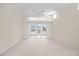 Bright living room with sliding glass doors to the backyard, carpeted flooring and modern fixtures at 4621 34Th E Ct, Bradenton, FL 34203