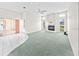 Spacious living room with carpet flooring, a ceiling fan, and fireplace at 4621 34Th E Ct, Bradenton, FL 34203