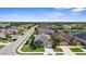 A scenic aerial view of a residential neighborhood with lush greenery and a serene pond at 4718 Arbor Gate Dr, Bradenton, FL 34203