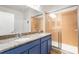 Bathroom featuring double sinks, granite countertop, and glass-enclosed shower at 4718 Arbor Gate Dr, Bradenton, FL 34203