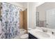 Full bathroom with blue vanity, white sink, floral shower curtain and shower-tub combo at 4718 Arbor Gate Dr, Bradenton, FL 34203