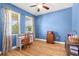 Inviting bedroom with two windows, hardwood floors, and a desk, bathed in soft natural light at 4718 Arbor Gate Dr, Bradenton, FL 34203