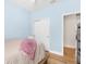 Cozy bedroom featuring light blue walls, wood floors, and closet space at 4718 Arbor Gate Dr, Bradenton, FL 34203