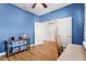 Comfortable bedroom with hardwood floors, open doorways, and a neutral color scheme at 4718 Arbor Gate Dr, Bradenton, FL 34203