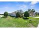 Well-maintained single Gathering home featuring a lush lawn, mature trees and two car garage at 4718 Arbor Gate Dr, Bradenton, FL 34203