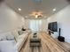 Bright living room with wood floors, recessed lighting, and a comfortable sofa at 4718 Arbor Gate Dr, Bradenton, FL 34203