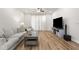 Comfortable living room with hardwood floors, neutral decor, and a sleek entertainment setup at 4718 Arbor Gate Dr, Bradenton, FL 34203