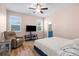 Main bedroom showing plush recliner, TV, wood floors, and ensuite bathroom at 4718 Arbor Gate Dr, Bradenton, FL 34203