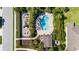 Birds eye view of a community pool and playground with ample seating and tropical landscaping at 4718 Arbor Gate Dr, Bradenton, FL 34203