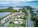 Enjoy the aerial view of the coastal property near the water with neighborhood and lush landscaping at 4840 Gulf Of Mexico Dr # Villa 15, Longboat Key, FL 34228