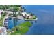 Beautiful aerial view of a waterfront property with boat docks, lush greenery, and serene blue waters at 4840 Gulf Of Mexico Dr # Villa 15, Longboat Key, FL 34228