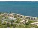 Beautiful aerial view of the property with nearby lake, condos, and surrounding greenery at 4840 Gulf Of Mexico Dr # Villa 15, Longboat Key, FL 34228