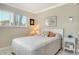 Cozy bedroom featuring neutral walls, bright window and a comfy bed with decorative pillows at 4840 Gulf Of Mexico Dr # Villa 15, Longboat Key, FL 34228