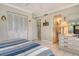 Comfortable bedroom featuring neutral walls, tile flooring, and convenient closet space at 4840 Gulf Of Mexico Dr # Villa 15, Longboat Key, FL 34228
