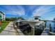 Modern boat docks showcasing several boats on lifts alongside a waterfront property with blue skies at 4840 Gulf Of Mexico Dr # Villa 15, Longboat Key, FL 34228