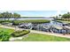 Multiple boats on lifts, docked within a community surrounded by green landscaping and waterfront access at 4840 Gulf Of Mexico Dr # Villa 15, Longboat Key, FL 34228