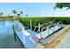 Private community dock featuring waterfront access, lush landscaping, and clear skies at 4840 Gulf Of Mexico Dr # Villa 15, Longboat Key, FL 34228
