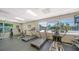 Featuring an interior gym with various treadmills, exercise bikes, and a bright window at 4840 Gulf Of Mexico Dr # Villa 15, Longboat Key, FL 34228