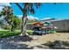 Kayak storage rack with colorful kayaks, set in a lush green outdoor area under a clear blue sky at 4840 Gulf Of Mexico Dr # Villa 15, Longboat Key, FL 34228