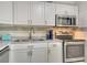 Well-equipped kitchen featuring stainless steel appliances, ample counter space, and white cabinetry at 4840 Gulf Of Mexico Dr # Villa 15, Longboat Key, FL 34228
