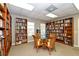This library features floor to ceiling bookcases and a central table with seating at 4840 Gulf Of Mexico Dr # Villa 15, Longboat Key, FL 34228