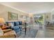 Comfortable living room showcasing tile floors, ample seating, and access to the outdoor space at 4840 Gulf Of Mexico Dr # Villa 15, Longboat Key, FL 34228