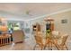 Bright living room featuring tile floors, a dining area, and comfortable furniture at 4840 Gulf Of Mexico Dr # Villa 15, Longboat Key, FL 34228