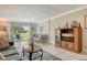 Bright living room with outdoor views, stylish furnishings, and decorative nautical accents at 4840 Gulf Of Mexico Dr # Villa 15, Longboat Key, FL 34228