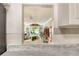 Open view from the kitchen to the living room and outdoor scenery at 4840 Gulf Of Mexico Dr # Villa 15, Longboat Key, FL 34228