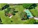 Aerial view of a shuffleboard court nestled in a beautifully landscaped green area with palm trees at 4840 Gulf Of Mexico Dr # Villa 15, Longboat Key, FL 34228