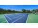 Enjoy a match on this well-maintained tennis court surrounded by lush landscaping and clear blue skies at 4840 Gulf Of Mexico Dr # Villa 15, Longboat Key, FL 34228