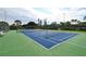 Well maintained tennis court with a green and blue playing surface, perfect for enjoying a sunny afternoon match at 4840 Gulf Of Mexico Dr # Villa 15, Longboat Key, FL 34228