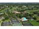 Aerial view of tennis courts, golf course, and community pool at 4920 Woodhurst Dr, Sarasota, FL 34243