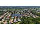 Aerial view of neighborhood with water views, lush landscapes, and golf course at 4920 Woodhurst Dr, Sarasota, FL 34243