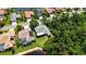 Aerial view of home surrounded by lush landscaping and a lake at 4920 Woodhurst Dr, Sarasota, FL 34243
