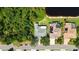 Aerial view of the home highlighting its proximity to lush greenery and a serene pond at 4920 Woodhurst Dr, Sarasota, FL 34243