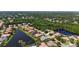 Beautiful aerial view of home surrounded by lush landscaping and serene water views at 4920 Woodhurst Dr, Sarasota, FL 34243