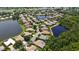 Beautiful aerial view of home with lush landscaping and water views at 4920 Woodhurst Dr, Sarasota, FL 34243