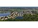 Expansive aerial view of the neighborhood featuring beautiful lakes and lush greenery at 4920 Woodhurst Dr, Sarasota, FL 34243