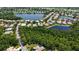 Aerial view showcasing the neighborhood's tranquil lakes, lush landscaping, and the home's location at 4920 Woodhurst Dr, Sarasota, FL 34243