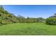 A sprawling back yard with meticulous landscaping that overlooks a serene lake at 4920 Woodhurst Dr, Sarasota, FL 34243