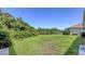 A sprawling back yard with meticulous landscaping that overlooks a serene lake at 4920 Woodhurst Dr, Sarasota, FL 34243