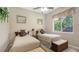 Comfortable bedroom with twin beds, soft lighting, and a view of the outside at 4920 Woodhurst Dr, Sarasota, FL 34243