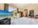 Bedroom with desk area, sliders, and large windows leading to screened-in porch at 4920 Woodhurst Dr, Sarasota, FL 34243