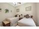 Inviting bedroom furnished with two twin beds, vintage art and soft overhead light at 4920 Woodhurst Dr, Sarasota, FL 34243