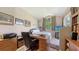 Bedroom with desk, large windows, neutral colors, and artwork on the walls at 4920 Woodhurst Dr, Sarasota, FL 34243