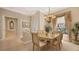 Cozy dining area with an elegant chandelier and ample natural light from the adjacent living spaces at 4920 Woodhurst Dr, Sarasota, FL 34243