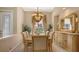 Bright dining room featuring a stylish chandelier, decorative mirror, and large windows at 4920 Woodhurst Dr, Sarasota, FL 34243