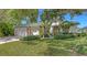 Beautiful one-story home featuring lush landscaping, a well-maintained lawn, and an attached two-car garage at 4920 Woodhurst Dr, Sarasota, FL 34243